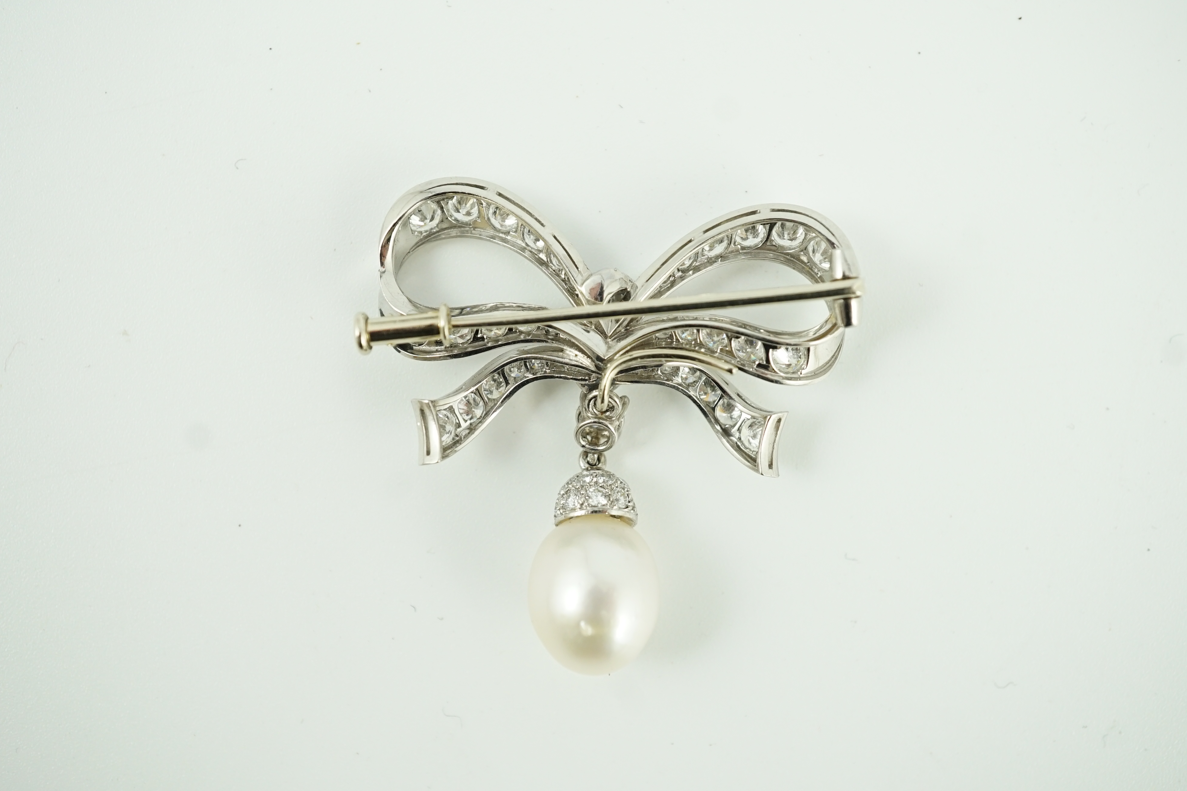 A late 20th century white gold, diamond cluster and single cultured pearl drop set ribbon bow brooch